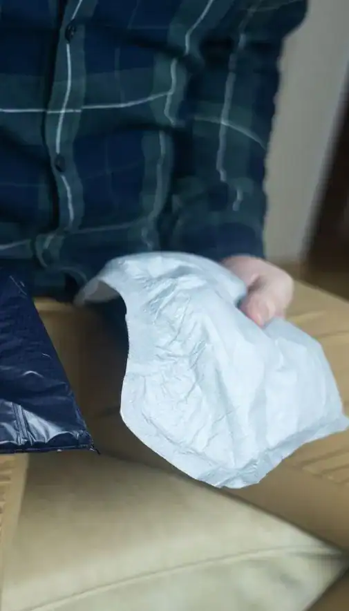 Image of man holding incontinence pads as part of overactive bladder treatment Canterbury