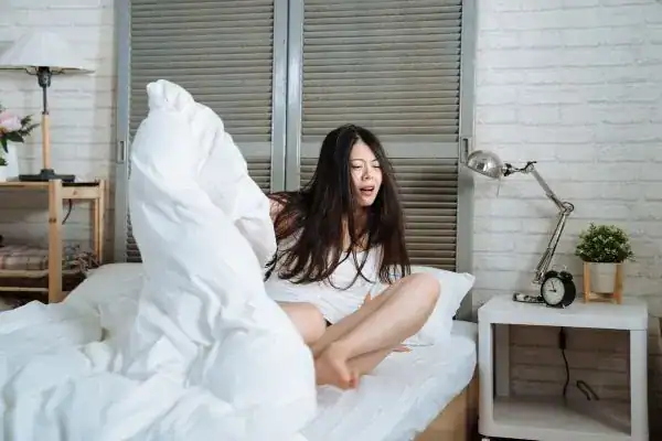 Image of woman getting up because of nighttime leaks Canterbury